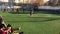 LVIV, UKRAINE - APRIL 14, 2019: Guys in the evening on a sunny day playing football on a mini artificial grass field