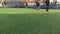 LVIV, UKRAINE - APRIL 14, 2019: Guys in the evening on a sunny day playing football on a mini artificial grass field