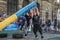 LVIV, UKRAINE - AUGUST 2017: A strong bodybuilder athlete lifts a huge steel heavy pipe to the strongman game in front of enthusia