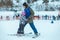 LVIV, UKRAINE - January 12, 2019: little girl novice skier. learning how to skiing