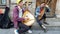 Lviv, Ukraine - July 16, 2019: Young bandura players playing the traditional Ukrainian musical instrument bandura on city street.