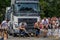 LVIV, UKRAINE - JULY 2016: Two strong athlete bodybuilder strongman pulling with ropes two huge truck in front of enthusiastic