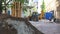 Lviv, Ukraine, July 5, 2021: Yellow large bucket excavator digging the ground to set the road. Excavator bucket scoops