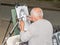 Lviv, Ukraine - June 2015: Painter paints a portrait of the street girl with pencil and paper for photos