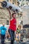 LVIV, UKRAINE - JUNE 2016: A strong man in the sports form bodybuilder lifts a heavy barbell on the street