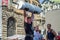 LVIV, UKRAINE - JUNE 2016: A strong man in the sports form bodybuilder lifts a heavy barbell on the street