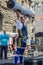 LVIV, UKRAINE - JUNE 2016: A strong man in the sports form bodybuilder lifts a heavy barbell on the street
