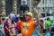 LVIV, UKRAINE - JUNE 2016: Strongman athlete with athletic inflated body lifts the heavy dumbbell on a city street