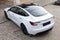 Lviv, Ukraine - March 23, 2024: White Tesla Model 3 highland electric car in showroom, trends in use EV in contemporary