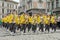 LVIV, UKRAINE - MAY 2018: A brass band with trumpets and saxophones in carnival costumes with yellow jackets is walking along the