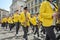 LVIV, UKRAINE - MAY 2018: A brass band with trumpets and saxophones in carnival costumes with yellow jackets is walking along the