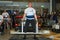 LVIV, UKRAINE - NOVEMBER 2016: Strong athlete strongman lifts a heavy car Toyota Corolla