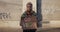 Lviv, Ukraine - November 27, 2019: Millennial female with Go vegan sign standing at empty street. African american woman