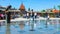 LVOV, UKRAINE - MAY 18, 2017: Children play and run among the fountains in Mytna Square, the Hlyniany Gate of medieval fortress ar