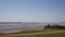 Lydney harbour view across the River Severn estuary towards the Severn bridge England uk with pan to picnic area and stones