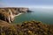 Lydstep Coastline, showing rock archway of a blow hole and Caldy Island