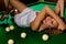 Lying on green snooker table