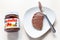 Lying jar of Nutella and toast with spread