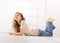 Lying young woman on floor talking on cellphone, with long hair