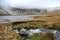 Lyn y fan fach lake in the winter, incoming stream of bubbling pure natural water, Brecon Beacons national park, Wales