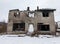 Lyngdal, Norway - january 2018: Broken burned concrete building in winter, snow on the ground. Norway