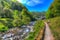 Lynmouth Devon River Lyn start of walk to Watersmeet looking back towards town in colourful hdr