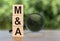 MA or Merger and Acquisition text on wooden blocks