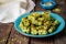 Maamoul - arabic cookies with pistachio in metal bowl on vintage wooden table background. Selective focus