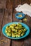 Maamoul - arabic cookies with pistachio in metal bowl on vintage wooden table background. Selective focus