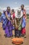 Maasai ladies collecting cow dung to use for house repair