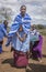 Maasai ladies collecting cow dung to use for house repair