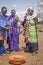 Maasai ladies collecting cow dung to use for house repair