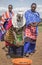 Maasai ladies collecting cow dung to use for house repair