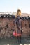 Maasai man, warrior, male lion mane on head, spear in hand, Tanzania