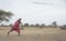 Maasai men practicing throwing a spear