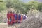 Maasai warriors arriving at a scene in a ceremonial slow walk