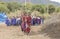 Maasai warriors arriving at a scene in a ceremonial slow walk