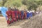 Maasai warriors arriving at a scene in a ceremonial slow walk