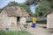 Maasai woamn in traditional clothing outside her home