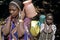 Maasai woman and child carrying drinking water