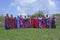 The Maasai women gather together for a dance wearing colorful robes and intricate ceremonial bib-like beaded necklace jewelry