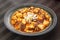 Mabo tofu with tomatoes soup and onion on chinese plate