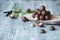 Macadamia kernels, walnut oil, on wooden background. Relax, health care, body care