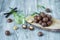 Macadamia kernels, walnut oil, on wooden background. Relax, health care, body care