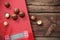 macadamia nuts on kitchen scales on wooden background