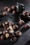 Macadamia nuts in a pewter vase. Vintage tableware. Large amounts of macadamia nuts. An expensive and nutritious nut. Vertical