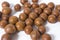 Macadamia nuts on white background. Cracked macadamia - organic and healthy food