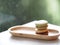 Macaron flavor green tea and coffee in wooden tray plate shape ellipse, Dessert snacks Afternoon on marble table blurred of nature