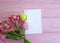 Macaron pink wooden background, alstroemeria flower white leaf