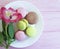 macaron wooden background white plate,alstroemeria flower france pastel gastronomy